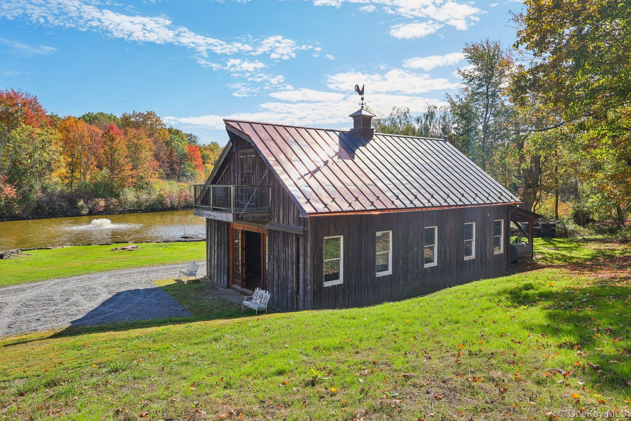101 Upper Wisner Road Warwick, NY 10990 - Photo 20 of 48 Back of property featuring a standing seam roof, a metal roof, a yard, a water view, and a chimney