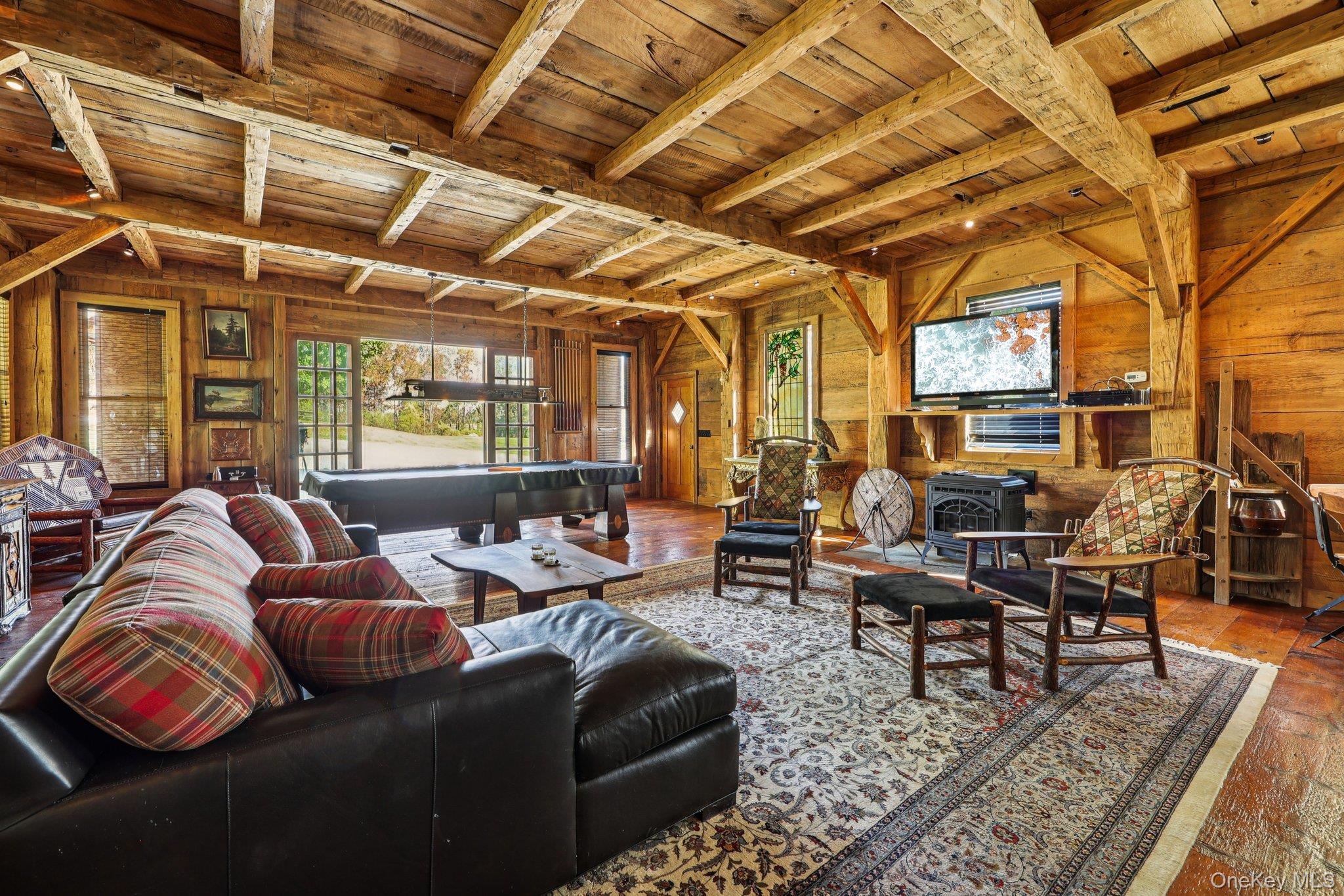 101 Upper Wisner Road Warwick, NY 10990 - Photo 25 of 48 Living room with a wood ceiling with exposed beams, a wood stove, and wooden walls