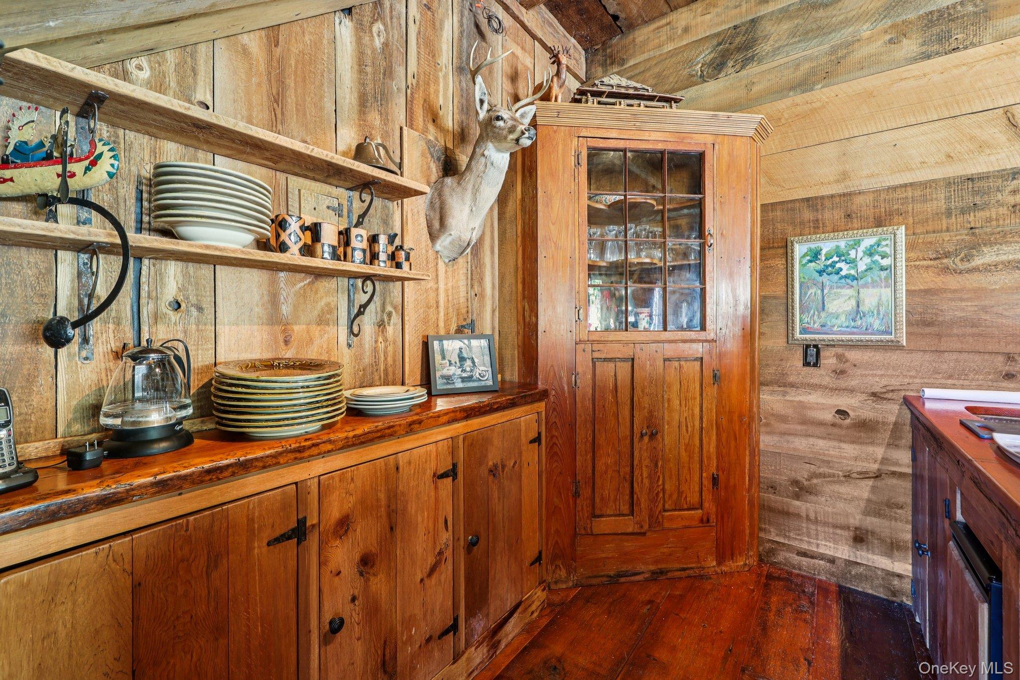 101 Upper Wisner Road Warwick, NY 10990 - Photo 27 of 48 Bar area with wooden walls, dark wood-style flooring, brown cabinets, open shelves, and wood counters