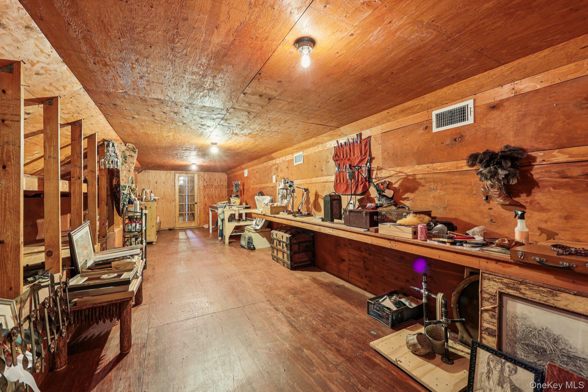 101 Upper Wisner Road Warwick, NY 10990 - Photo 29 of 48 Miscellaneous room with wood-type flooring, wood walls, and a workshop area