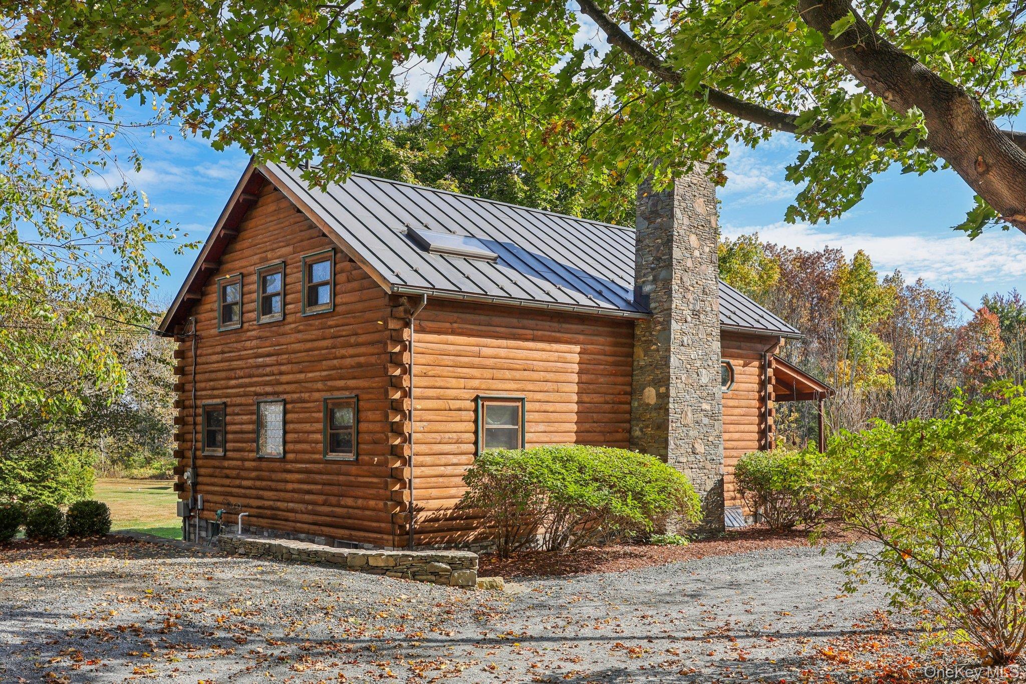 101 Upper Wisner Road Warwick, NY 10990 - Photo 32 of 48 View of side of property with a standing seam roof, a metal roof, a chimney, and log exterior