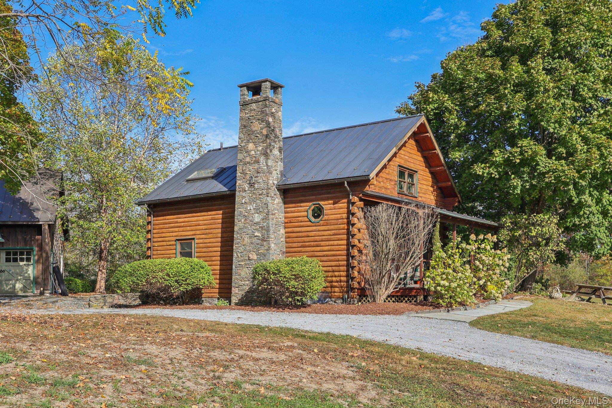 101 Upper Wisner Road Warwick, NY 10990 - Photo 33 of 48 View of home's exterior with log exterior, a chimney, a metal roof, and a lawn