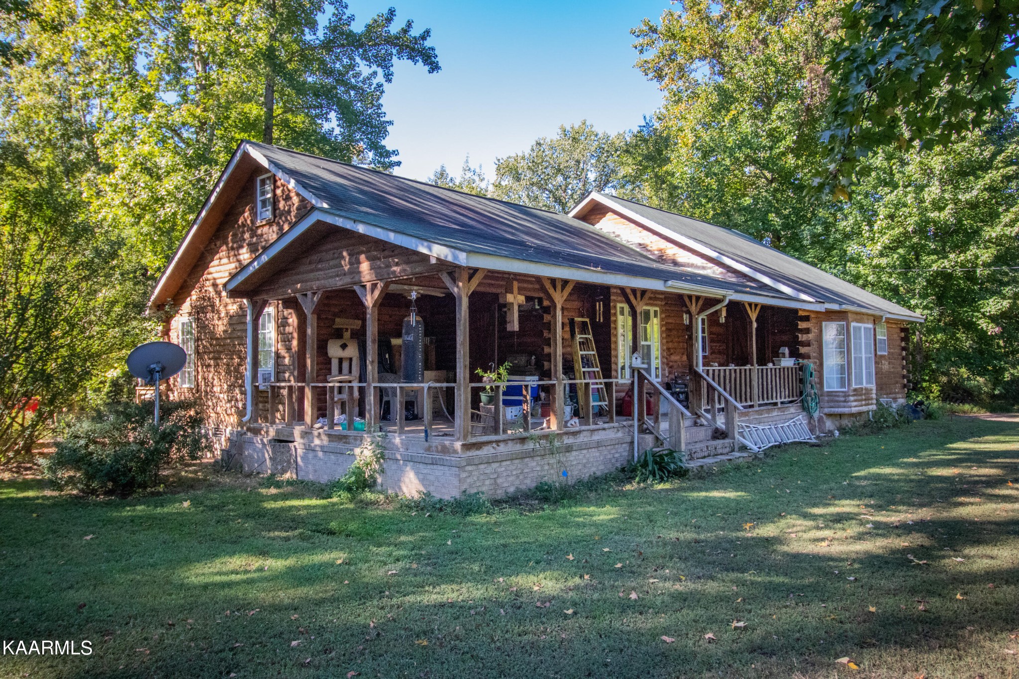 3879 Roan Creek Road Lobelville, TN 37097 - Photo 1 of 45 a front view of house with a garden and patio