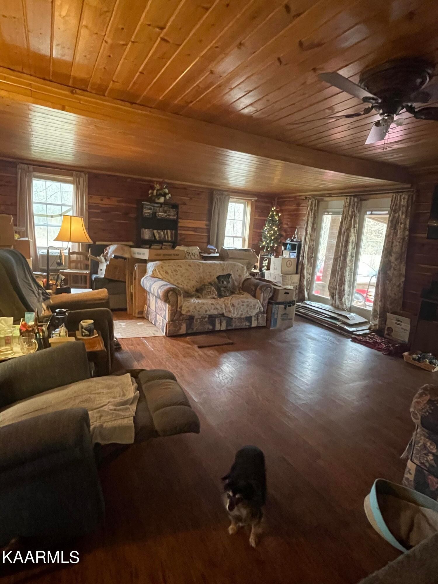 3879 Roan Creek Road Lobelville, TN 37097 - Photo 18 of 45 a living room with patio furniture and a chandelier