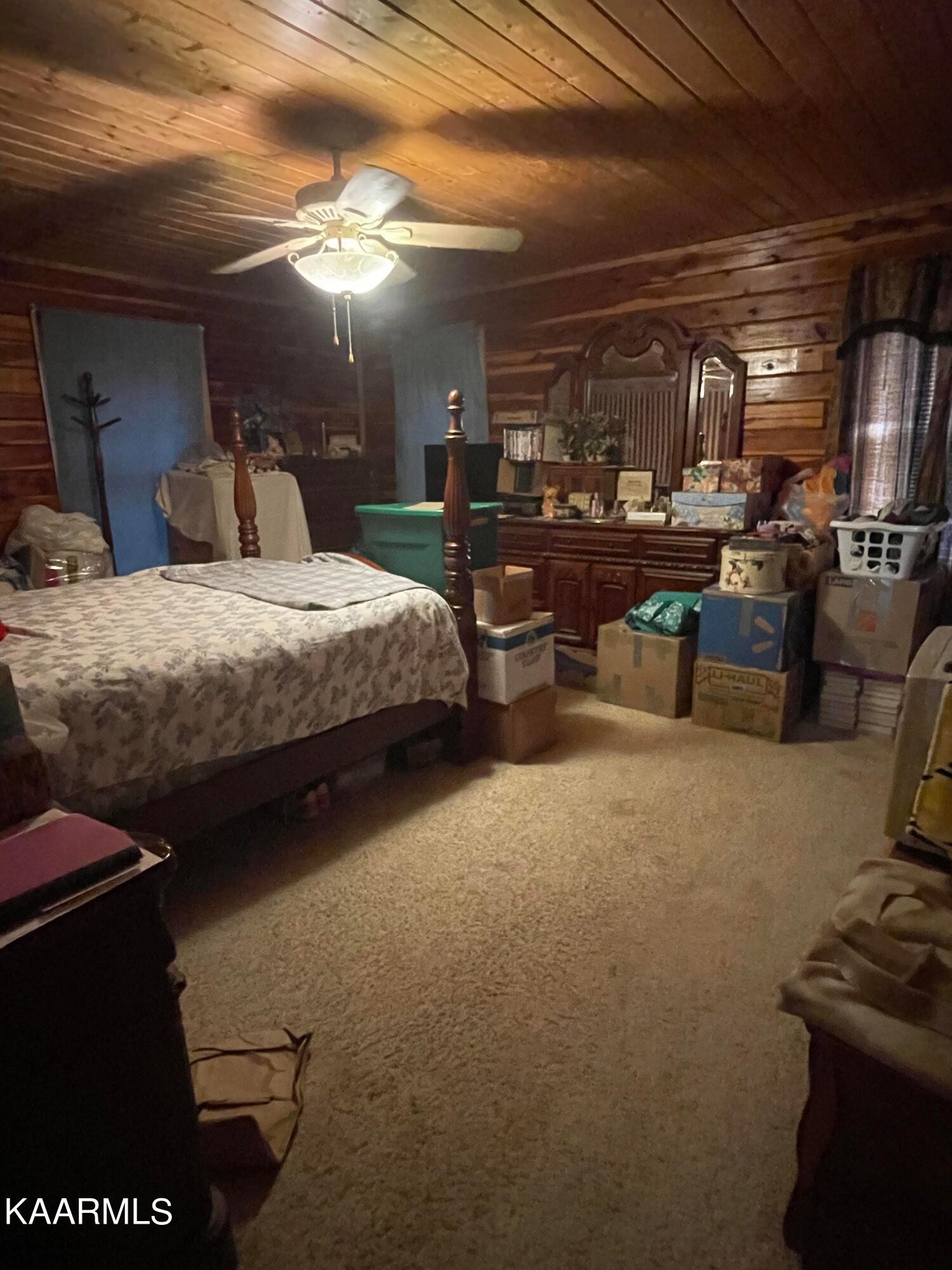 3879 Roan Creek Road Lobelville, TN 37097 - Photo 27 of 45 a bedroom with furniture and a car