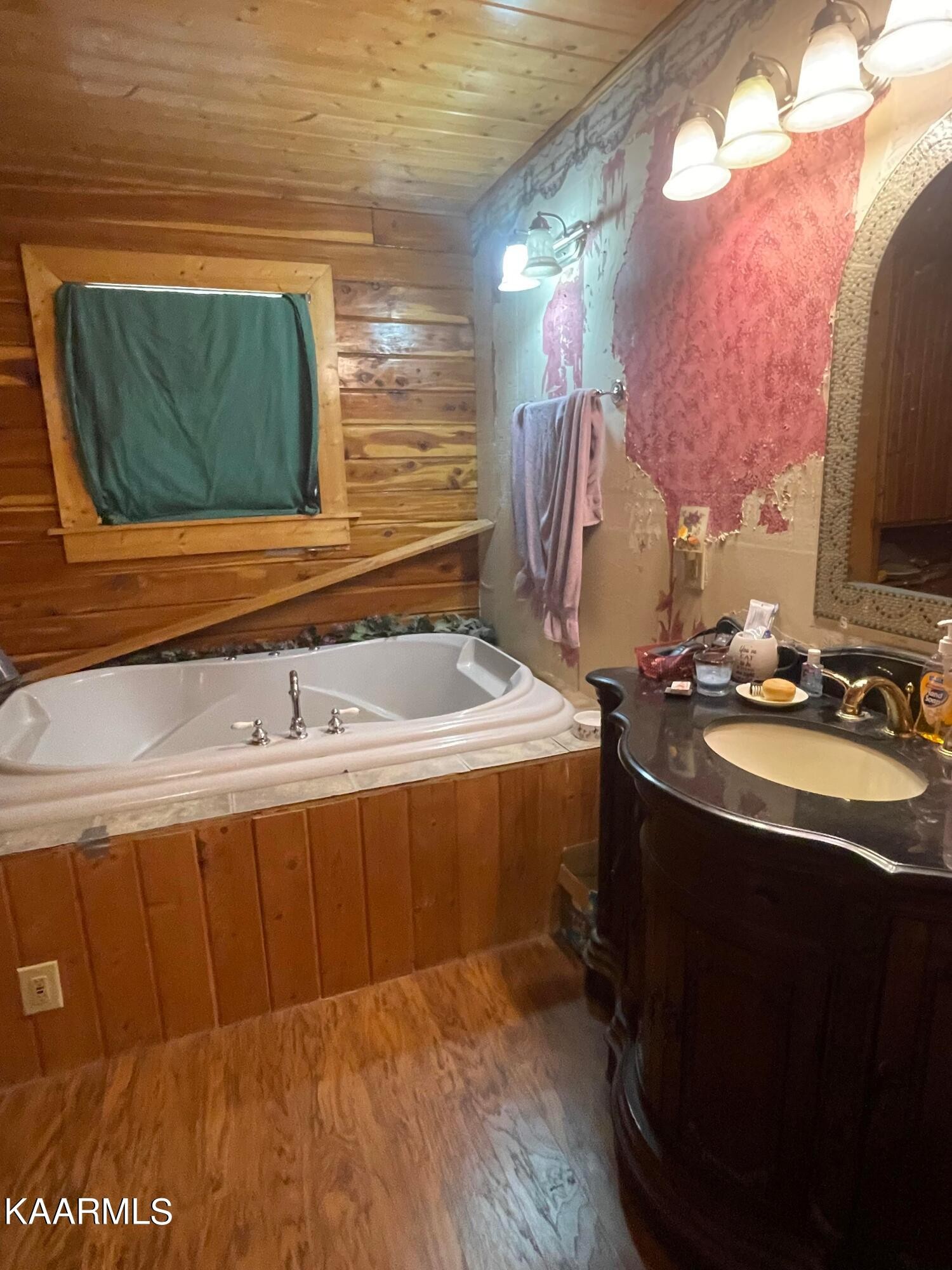3879 Roan Creek Road Lobelville, TN 37097 - Photo 31 of 45 a bathroom with a sink double vanity and a mirror