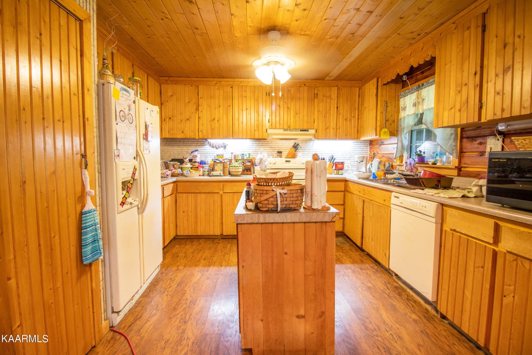 3879 Roan Creek Road Lobelville, TN 37097 - Photo 40 of 45 a kitchen with lots of counter top space and wooden floor