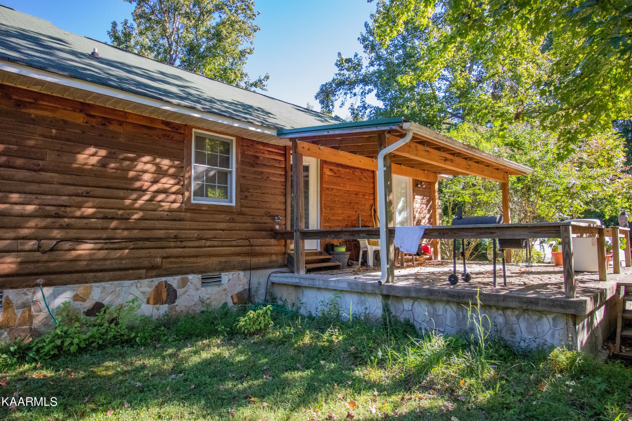 3879 Roan Creek Road Lobelville, TN 37097 - Photo 5 of 45 a backyard of a house with seating space