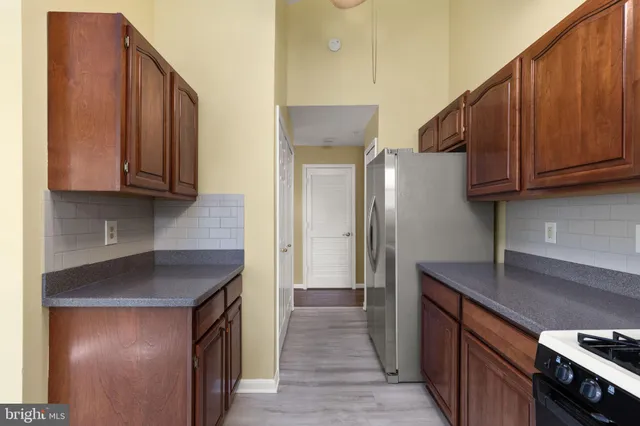 a kitchen with stainless steel appliances granite countertop wooden cabinets a sink and a stove