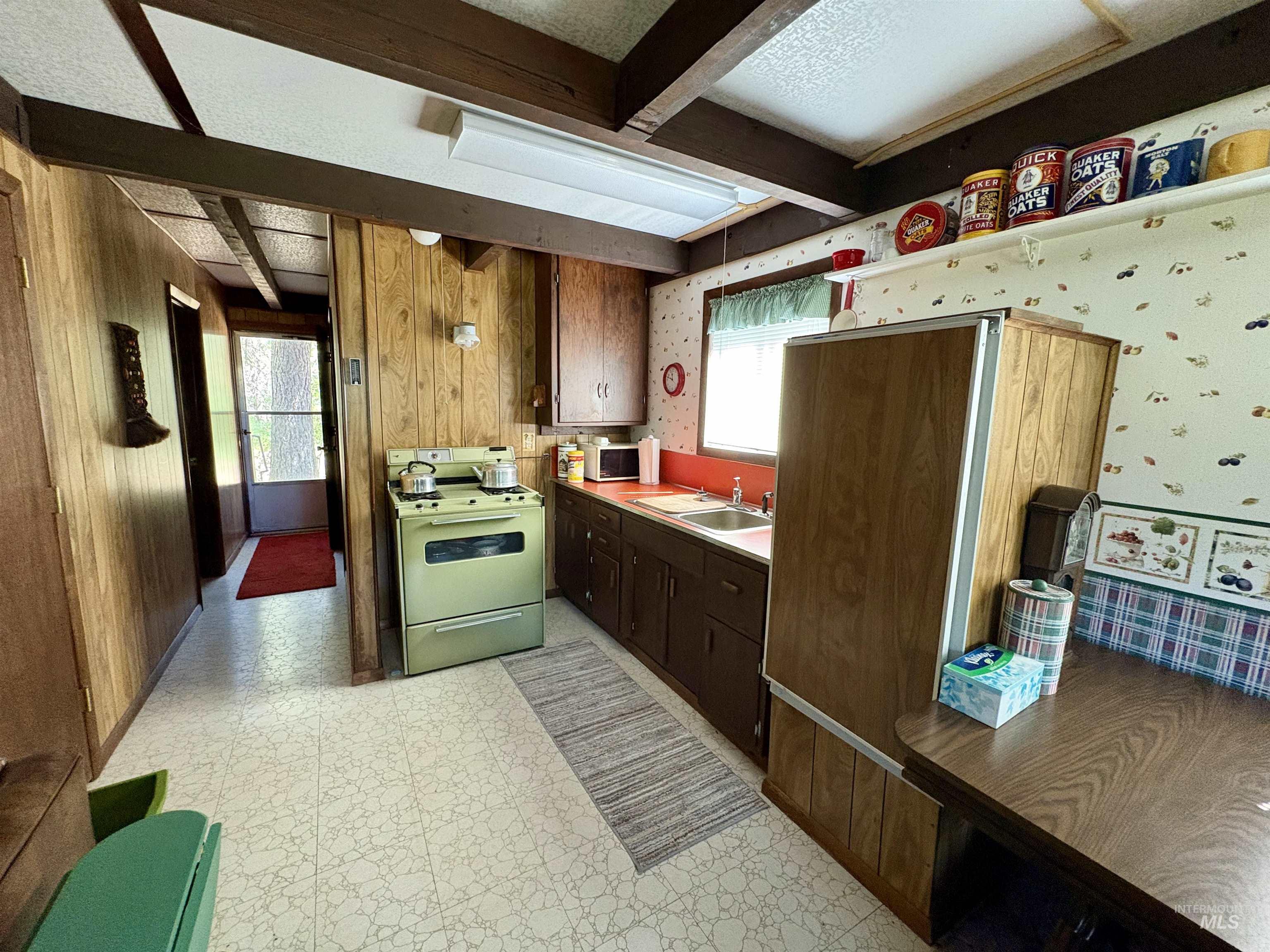 1100 Strawberry Loop Road Mountain Home, ID 83647 - Photo 15 of 20 Spacious wooden deck featuring a ceiling with exposed joists, a wooden railing, and a slatted wood floor