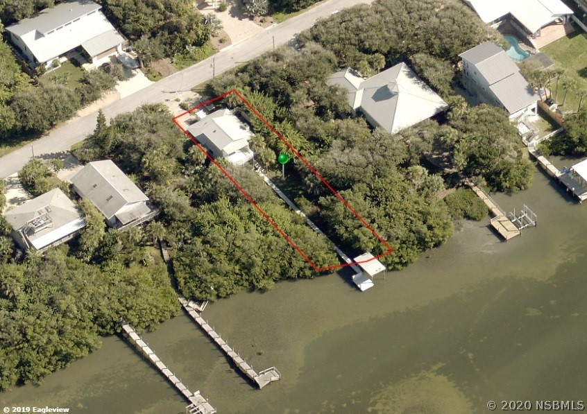 6312 River Road New Smyrna Beach, FL 32169 - Photo 3 of 33 an aerial view of a house with a yard and street