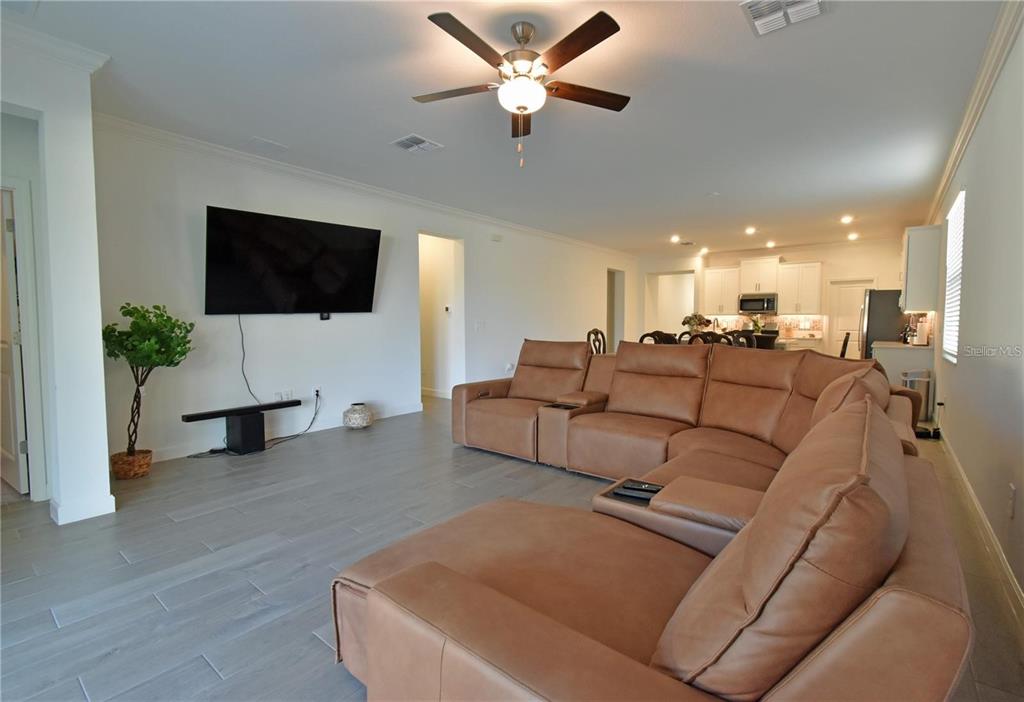17304 Banded Gold Lane Wimauma, FL 33598 - Photo 20 of 44 a living room with furniture and a flat screen tv