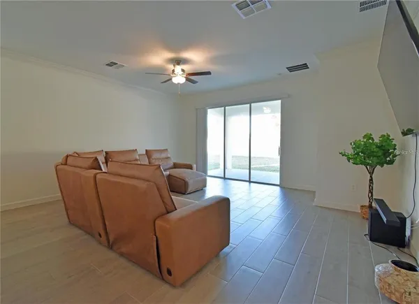 a living room with furniture potted plant and window