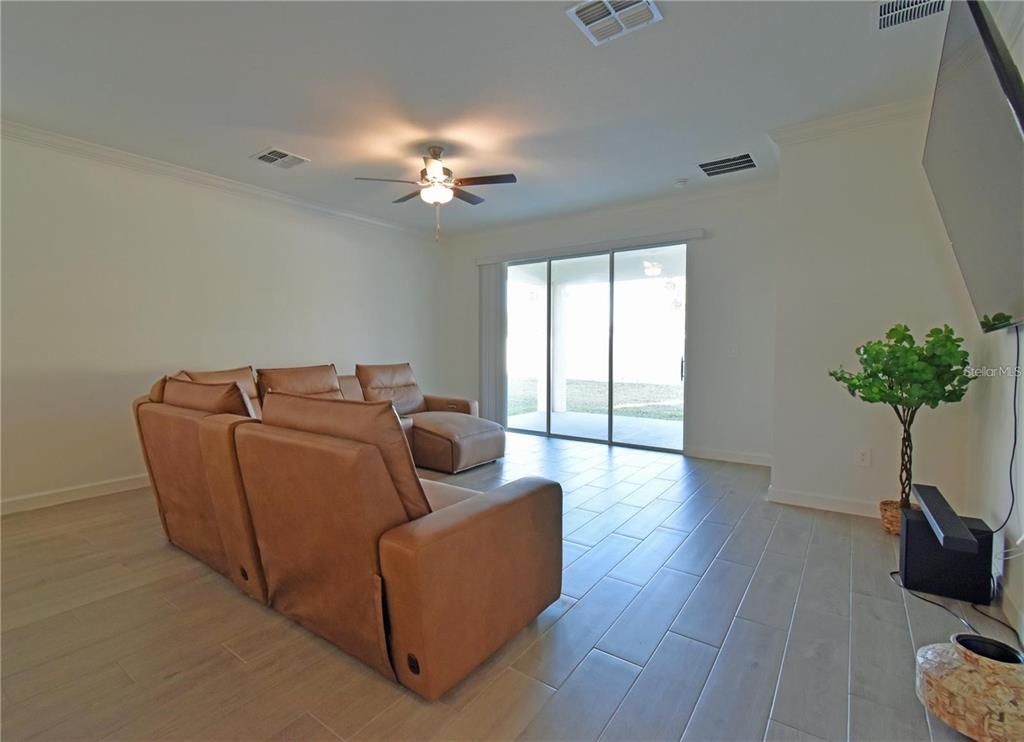 17304 Banded Gold Lane Wimauma, FL 33598 - Photo 22 of 44 a living room with furniture potted plant and window