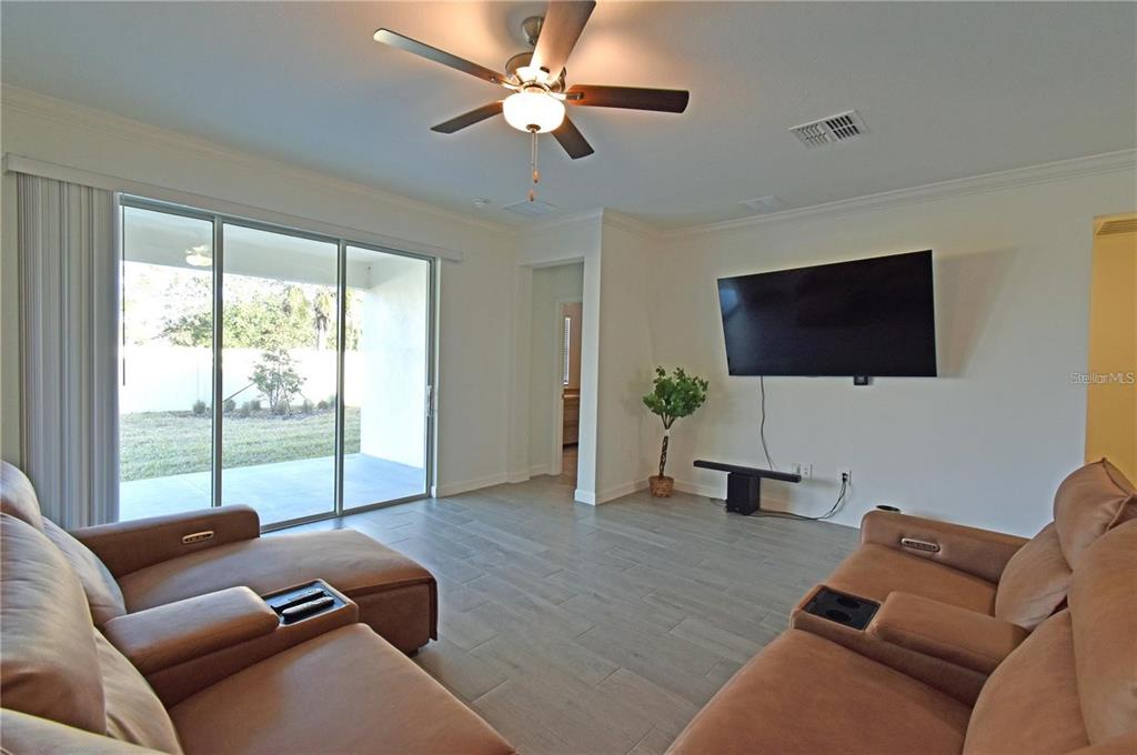 17304 Banded Gold Lane Wimauma, FL 33598 - Photo 23 of 44 a living room with furniture and a flat screen tv