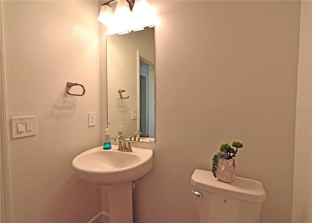 17304 Banded Gold Lane Wimauma, FL 33598 - Photo 24 of 44 a bathroom with a sink and a mirror