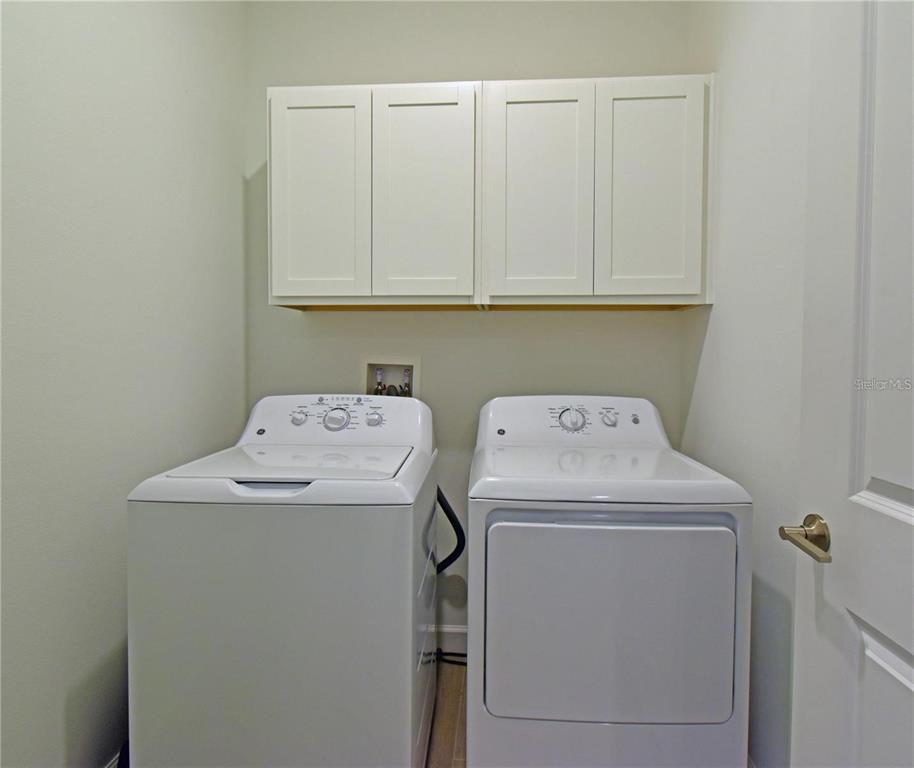 17304 Banded Gold Lane Wimauma, FL 33598 - Photo 26 of 44 a utility room with dryer and washer