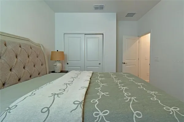 a bedroom with a bed and cabinets