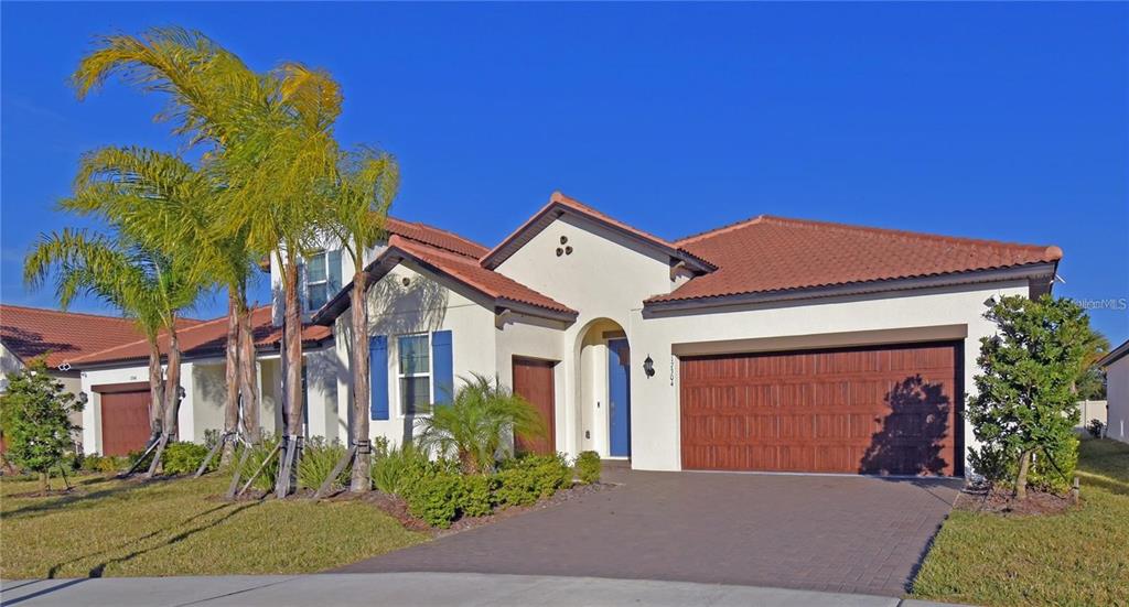 17304 Banded Gold Lane Wimauma, FL 33598 - Photo 3 of 44 a front view of a house with a yard