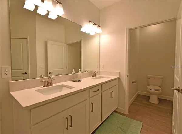 a bathroom with a double vanity sink and a mirror