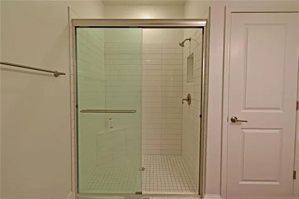 a bathroom with a glass shower door