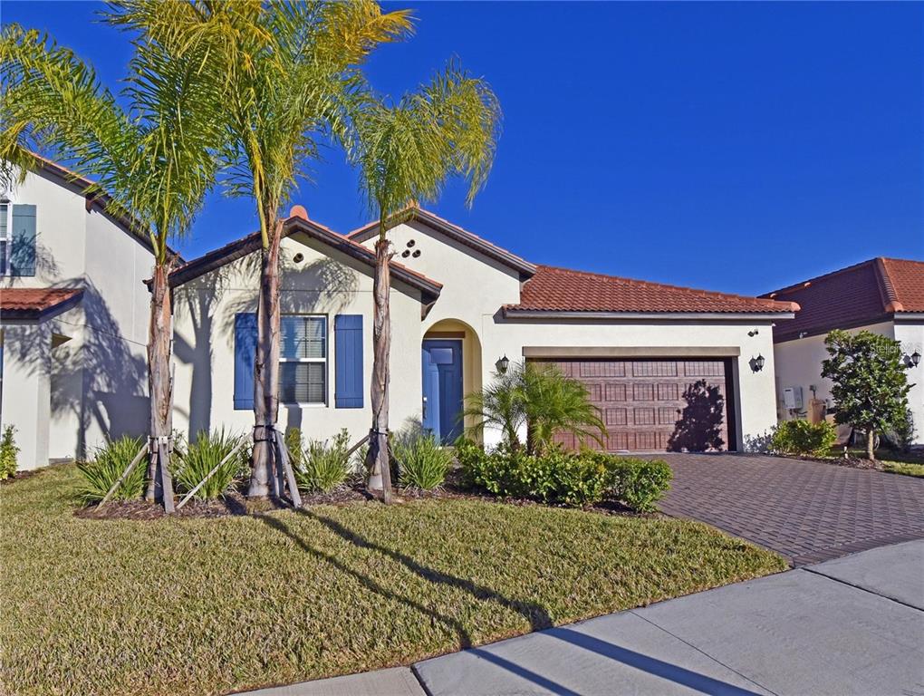 17304 Banded Gold Lane Wimauma, FL 33598 - Photo 4 of 44 a front view of a house with a yard
