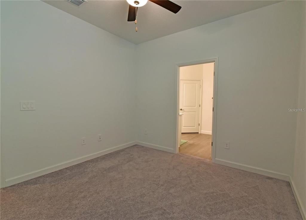 17304 Banded Gold Lane Wimauma, FL 33598 - Photo 43 of 44 an empty room with a empty space and a window