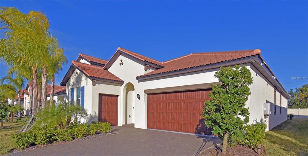 17304 Banded Gold Lane Wimauma, FL 33598 - Photo 5 of 44 front view of a house with a yard