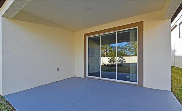 a view of an empty room with a fireplace and a window