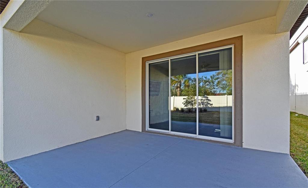 17304 Banded Gold Lane Wimauma, FL 33598 - Photo 8 of 44 a view of an empty room with a fireplace and a window