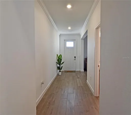 a view of a hallway with wooden floor