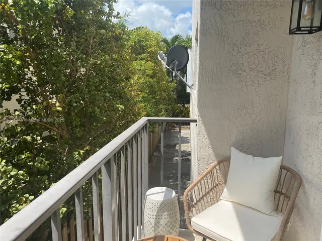 a balcony with wooden floor and outdoor space