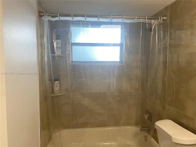 a bathroom with a shower and a toilet