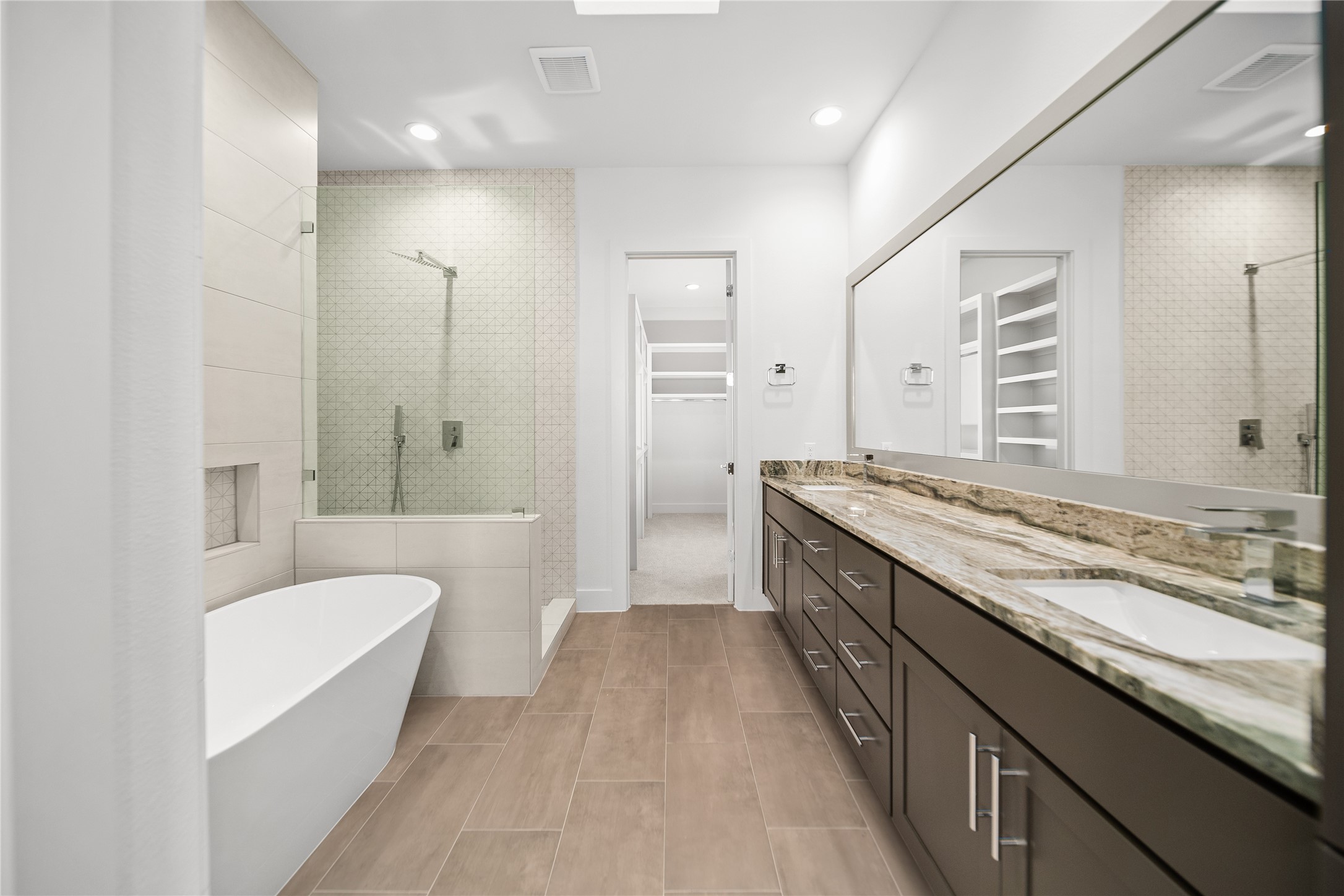 2408 Gray Street Houston, TX 77003 - Photo 10 of 23 a bathroom with a granite countertop double vanity sink a mirror and a bathtub