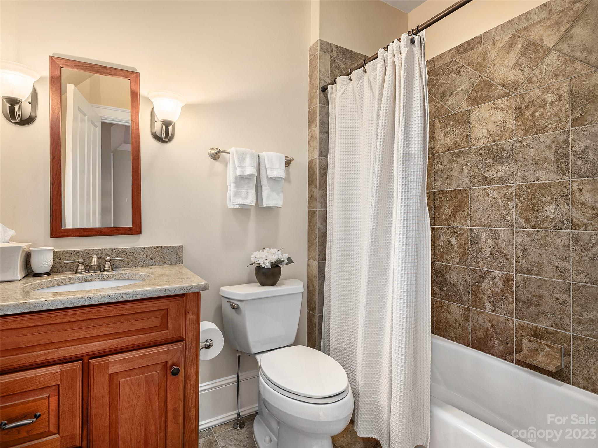 113 Willow Farm Road Fairview, NC 28730 - Photo 23 of 48 a bathroom with a granite countertop sink toilet and shower
