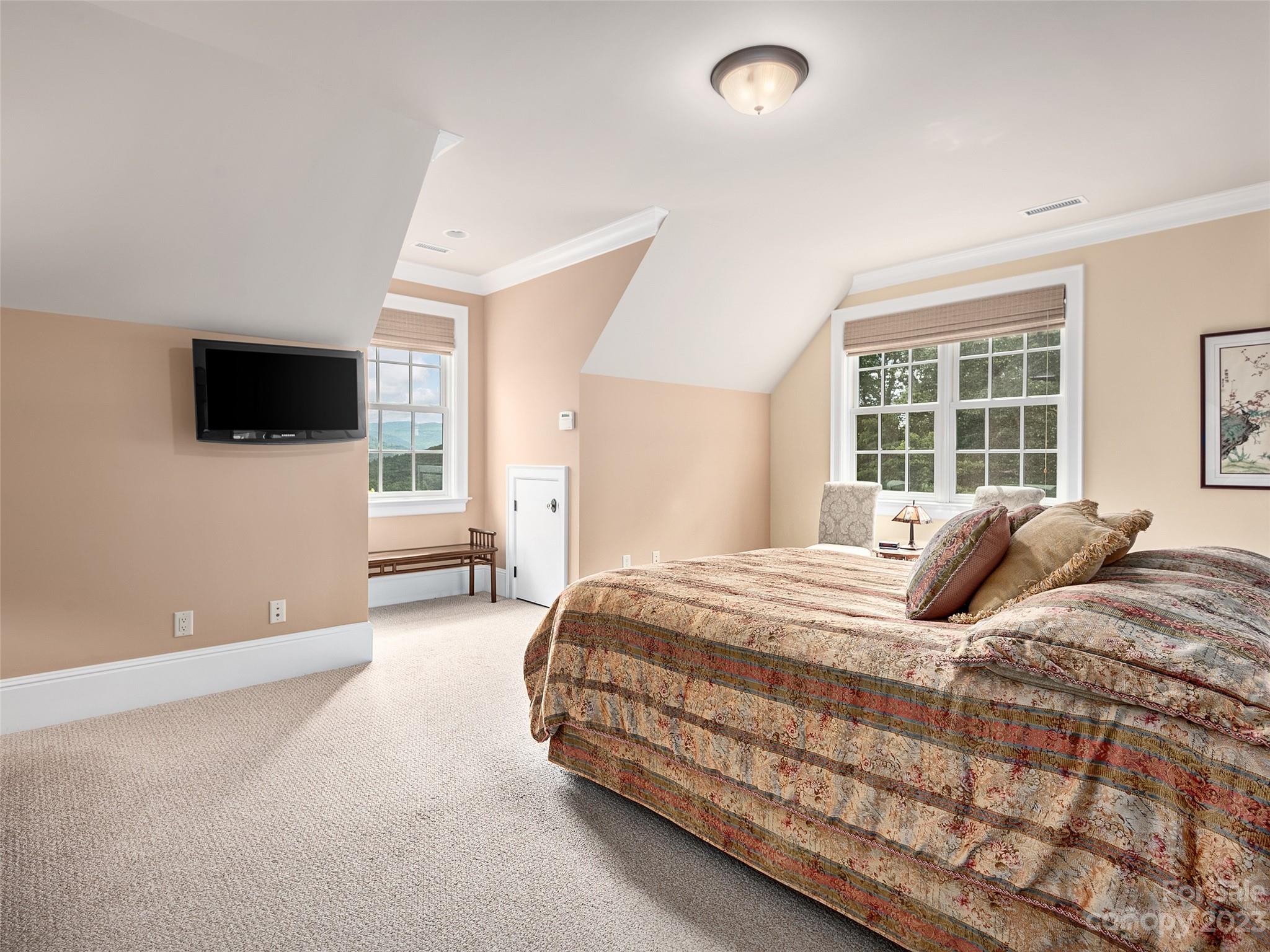 113 Willow Farm Road Fairview, NC 28730 - Photo 24 of 48 a bedroom with a bed and a flat screen tv