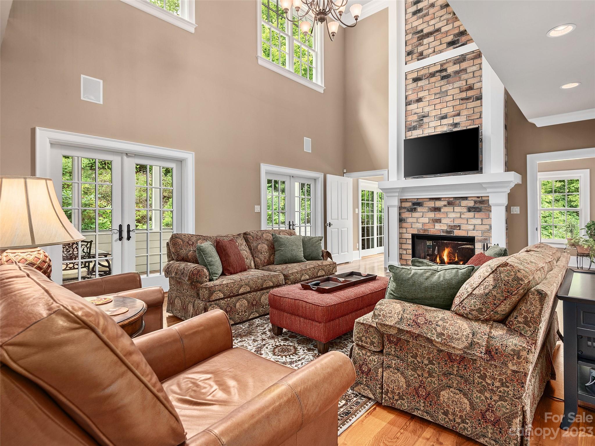 113 Willow Farm Road Fairview, NC 28730 - Photo 6 of 48 a living room with furniture a fireplace and a flat screen tv