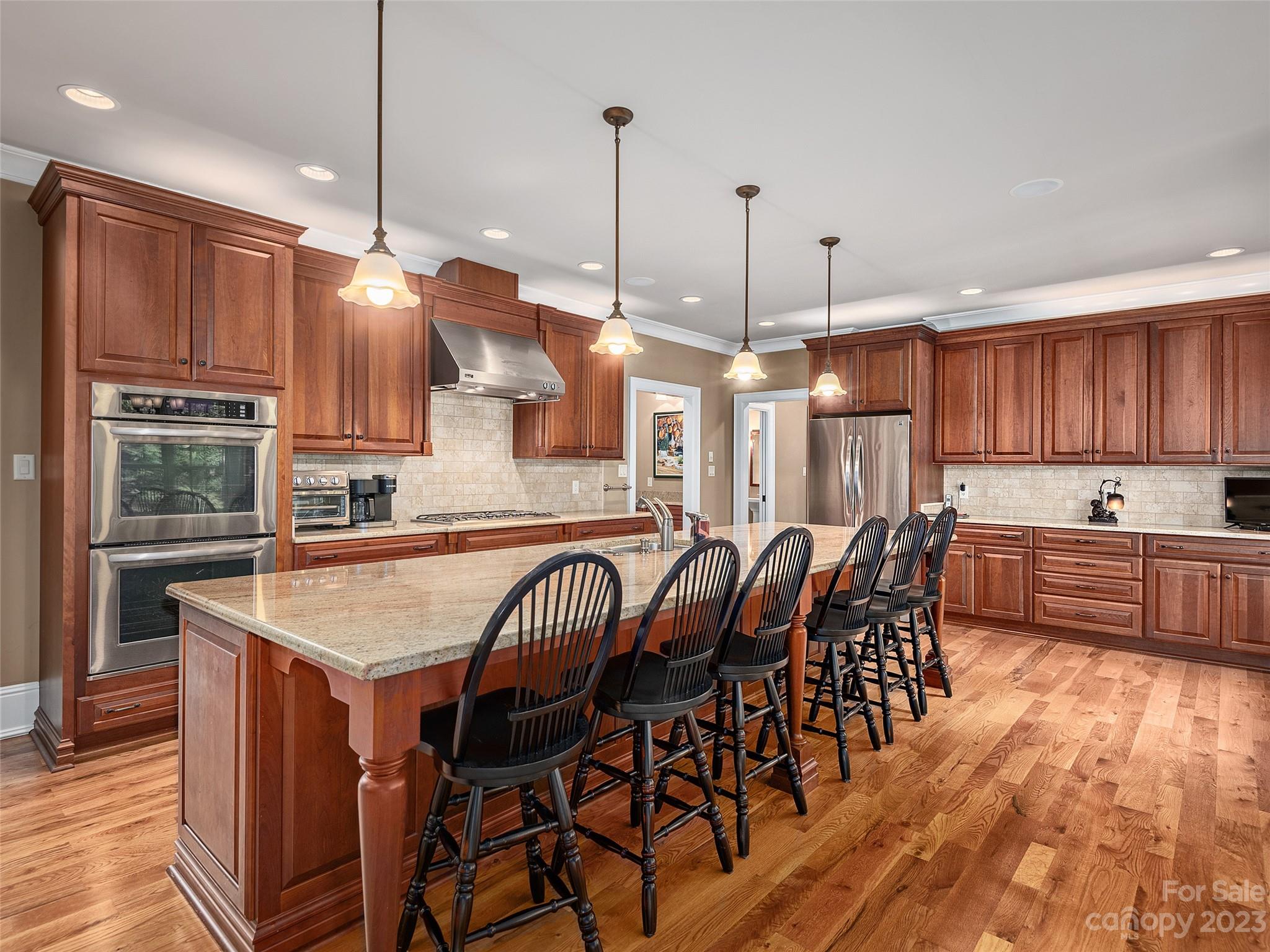 113 Willow Farm Road Fairview, NC 28730 - Photo 10 of 48 a kitchen with stainless steel appliances granite countertop a kitchen island a stove a table and chairs