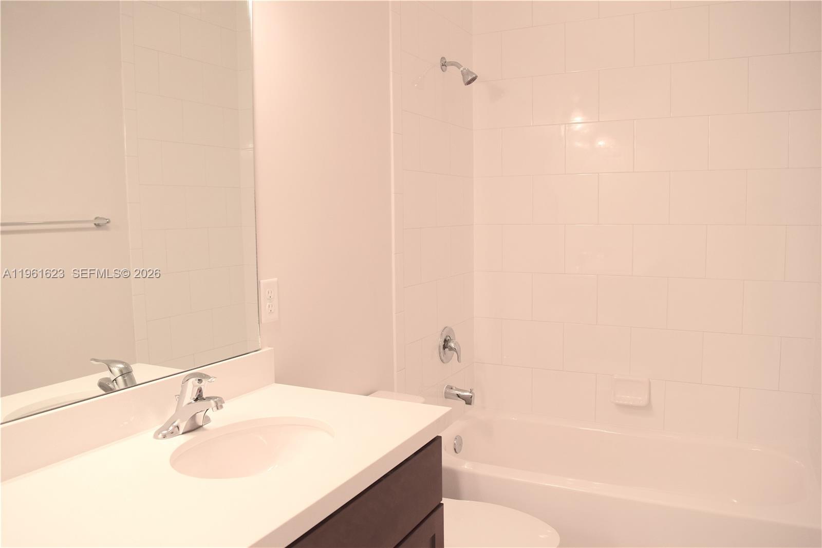 8416 West McNab Road, Unit 8416 Tamarac, FL 33321 - Photo 15 of 25 a bathroom with a sink and a mirror
