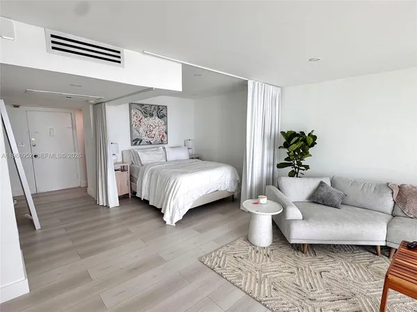 a bedroom with a large bed and a couch