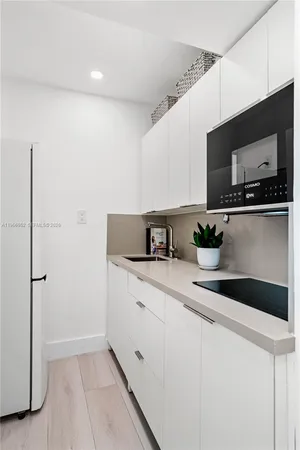 a kitchen with stainless steel appliances a sink and a microwave