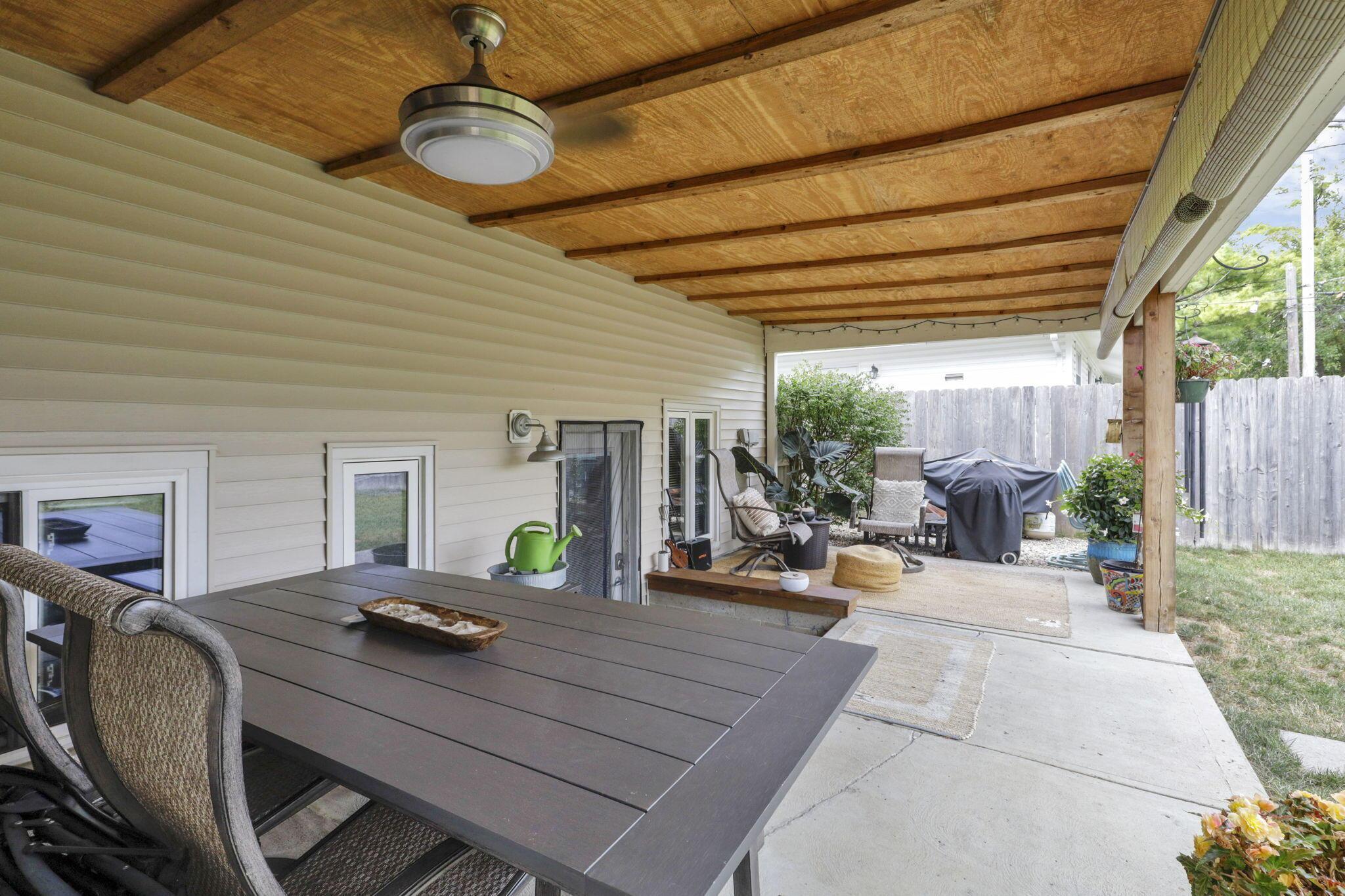 450 Deerfield Road Columbus, OH 43228 - Photo 22 of 28 Awesome covered porch overlooking the private fenced yard with lush landscaping