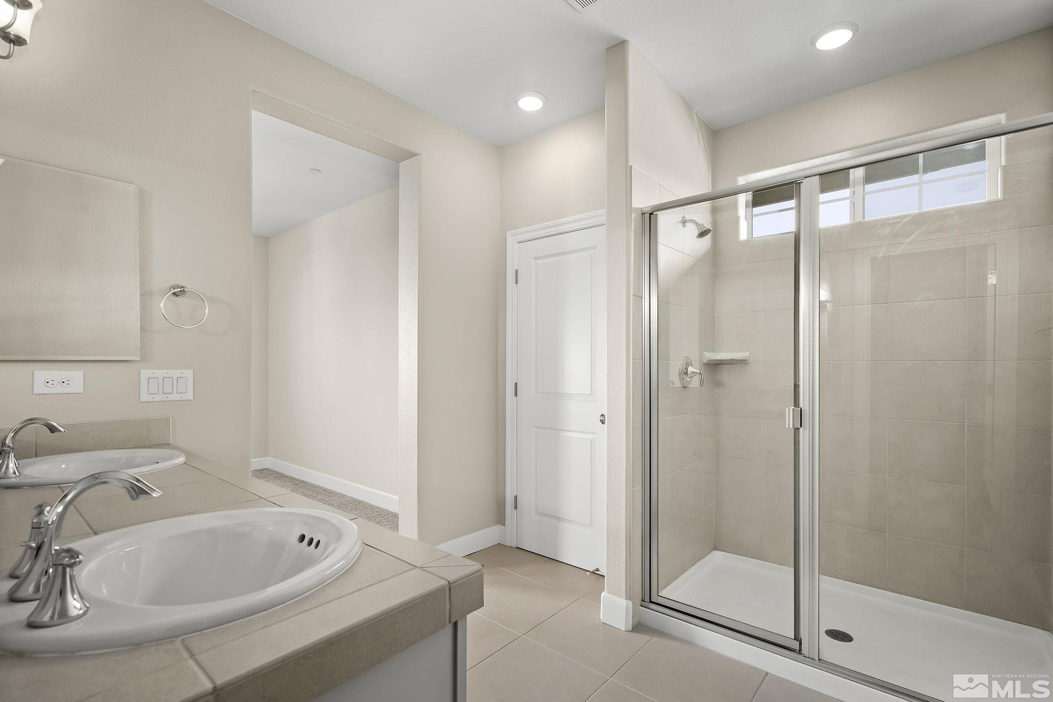 1855 Sea Horse Road, Unit A Reno, NV 89521 - Photo 14 of 32 a bathroom with a shower and a sink