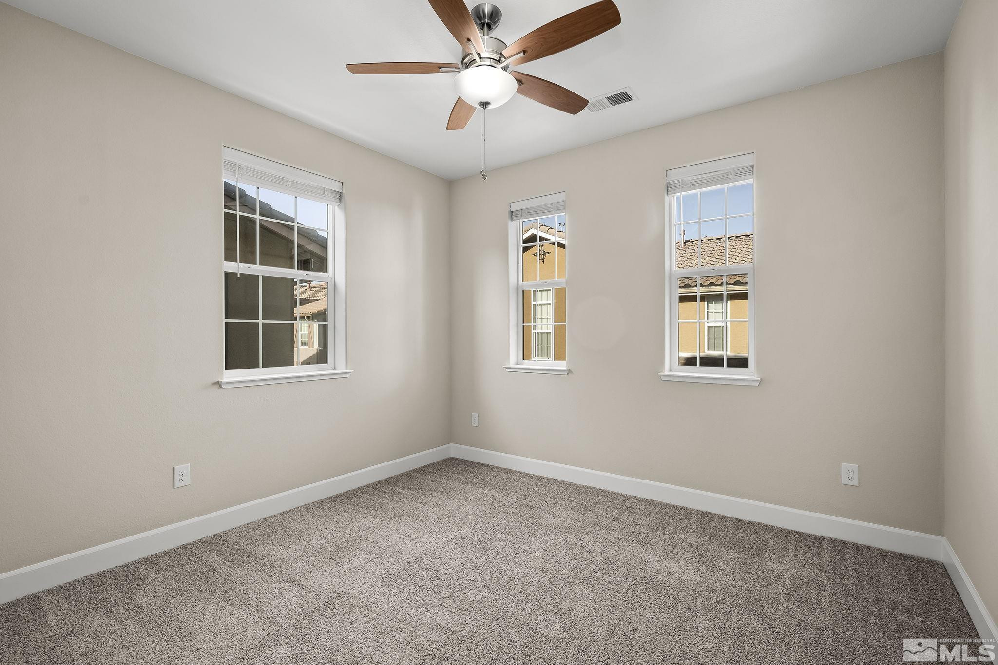 1855 Sea Horse Road, Unit A Reno, NV 89521 - Photo 15 of 32 a view of an empty room with a window and a ceiling fan