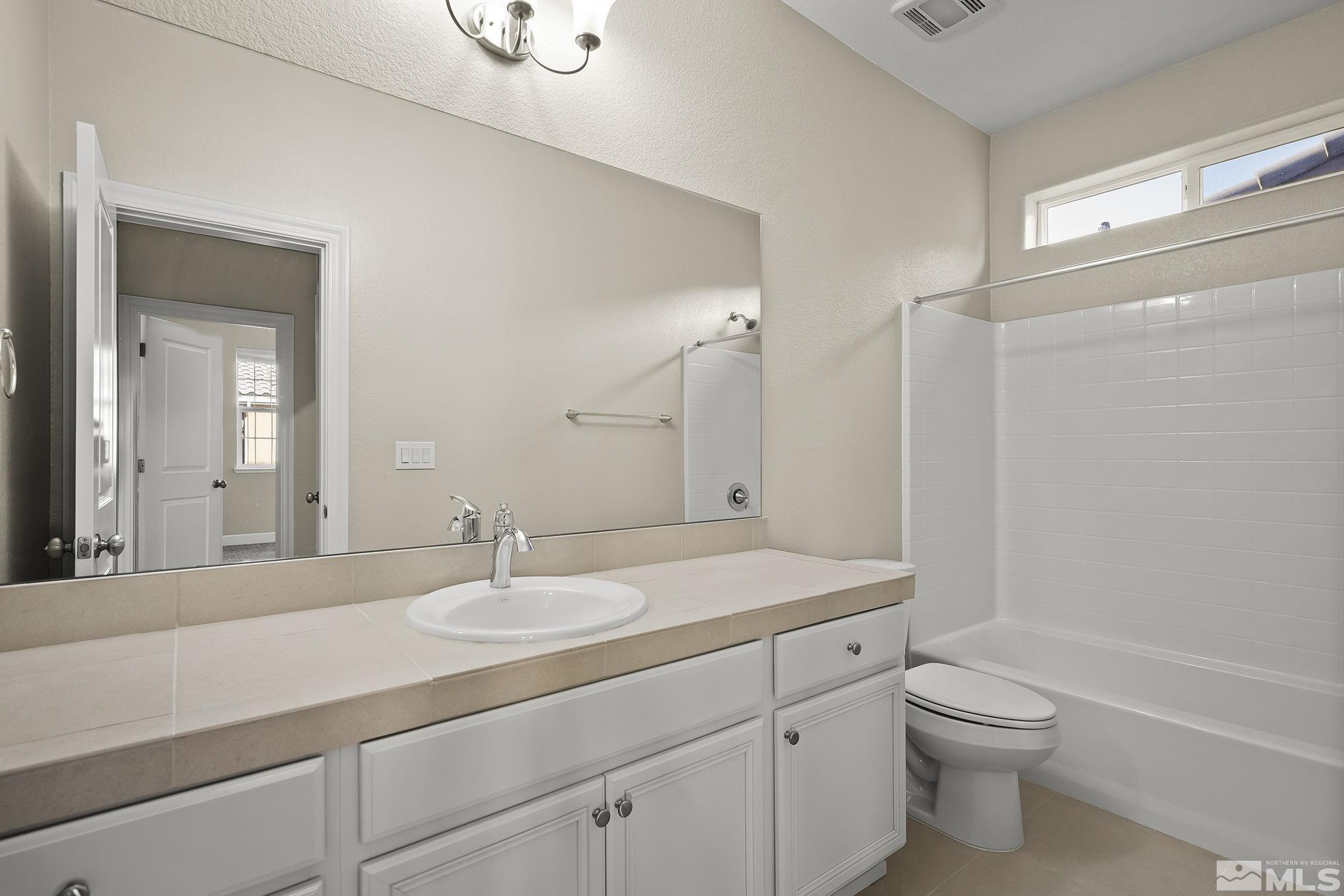 1855 Sea Horse Road, Unit A Reno, NV 89521 - Photo 17 of 32 a bathroom with a sink a toilet and shower