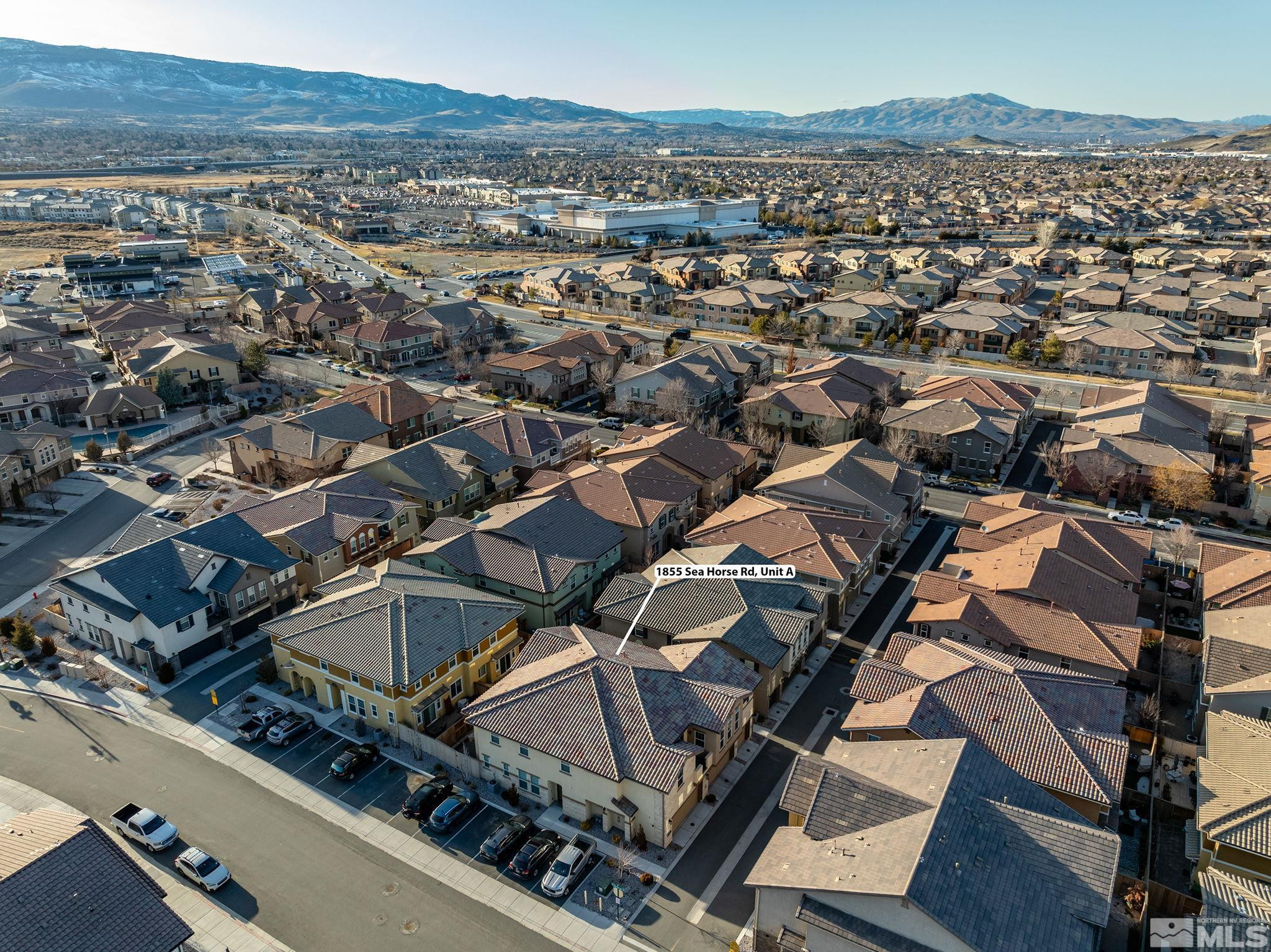 1855 Sea Horse Road, Unit A Reno, NV 89521 - Photo 22 of 32 an aerial view of a residential apartment building and mountain view