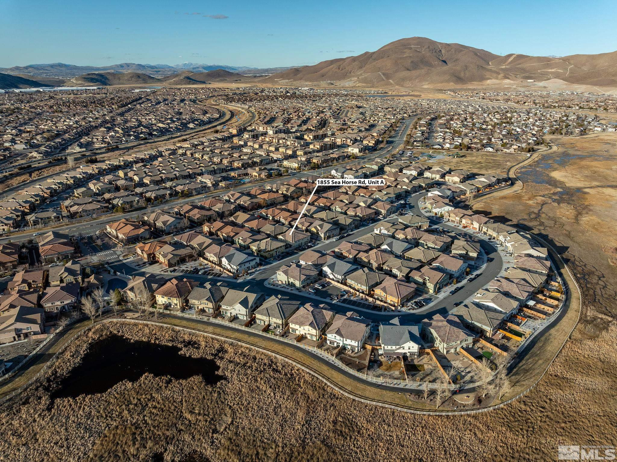 1855 Sea Horse Road, Unit A Reno, NV 89521 - Photo 31 of 32 an aerial view of a residential apartment building in front of a house