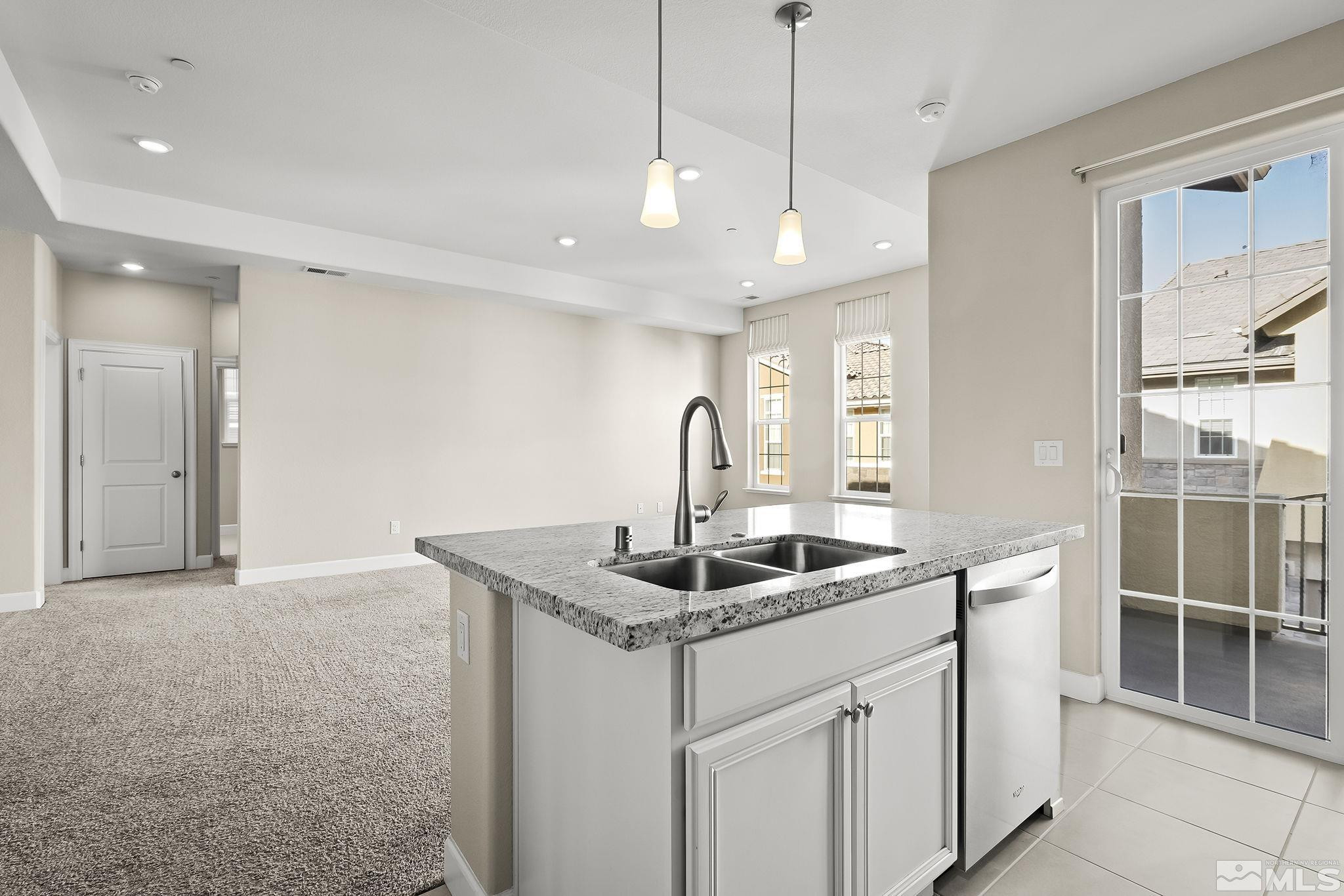 1855 Sea Horse Road, Unit A Reno, NV 89521 - Photo 9 of 32 a kitchen with stainless steel appliances granite countertop a sink and dishwasher