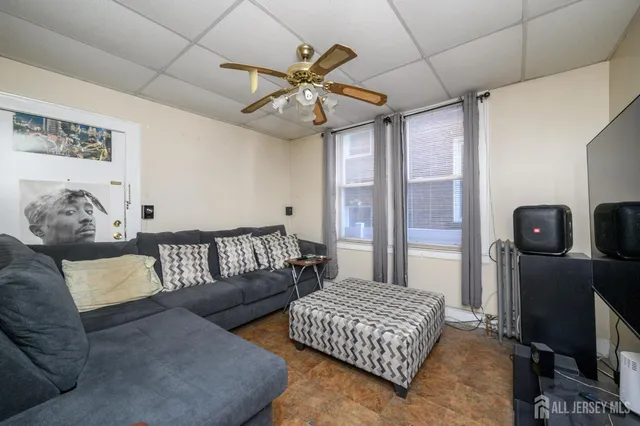 a living room with furniture and a chandelier
