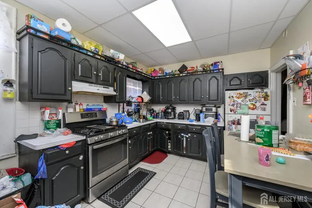 a living room with furniture stairs and a baby crib